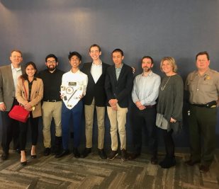 A local high school design team and Gateway Arch National Park ranger pose for a photo at the annual Gateway Arch Engineering Contest