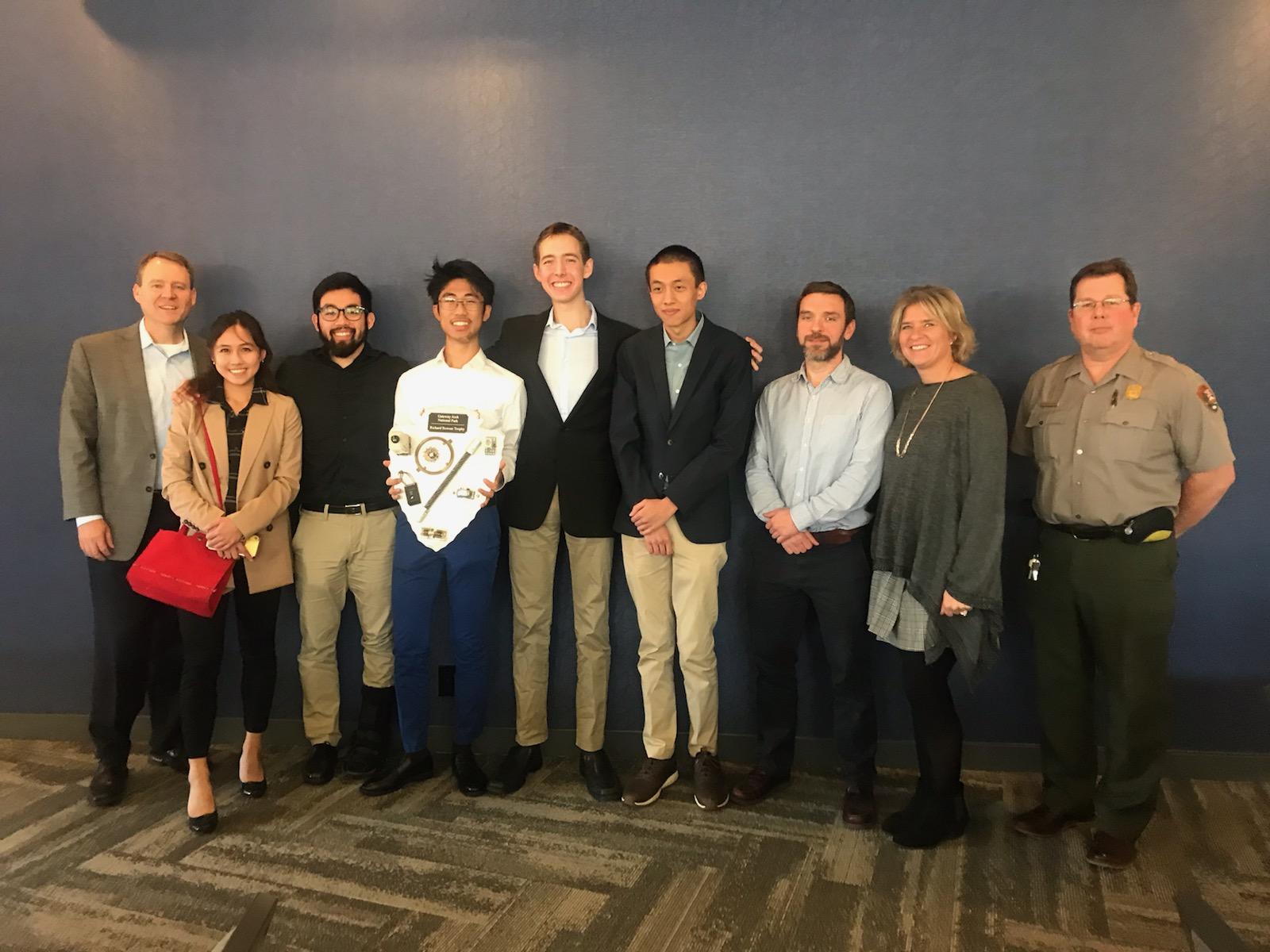 A local high school design team and Gateway Arch National Park ranger pose for a photo at the annual Gateway Arch Engineering Contest